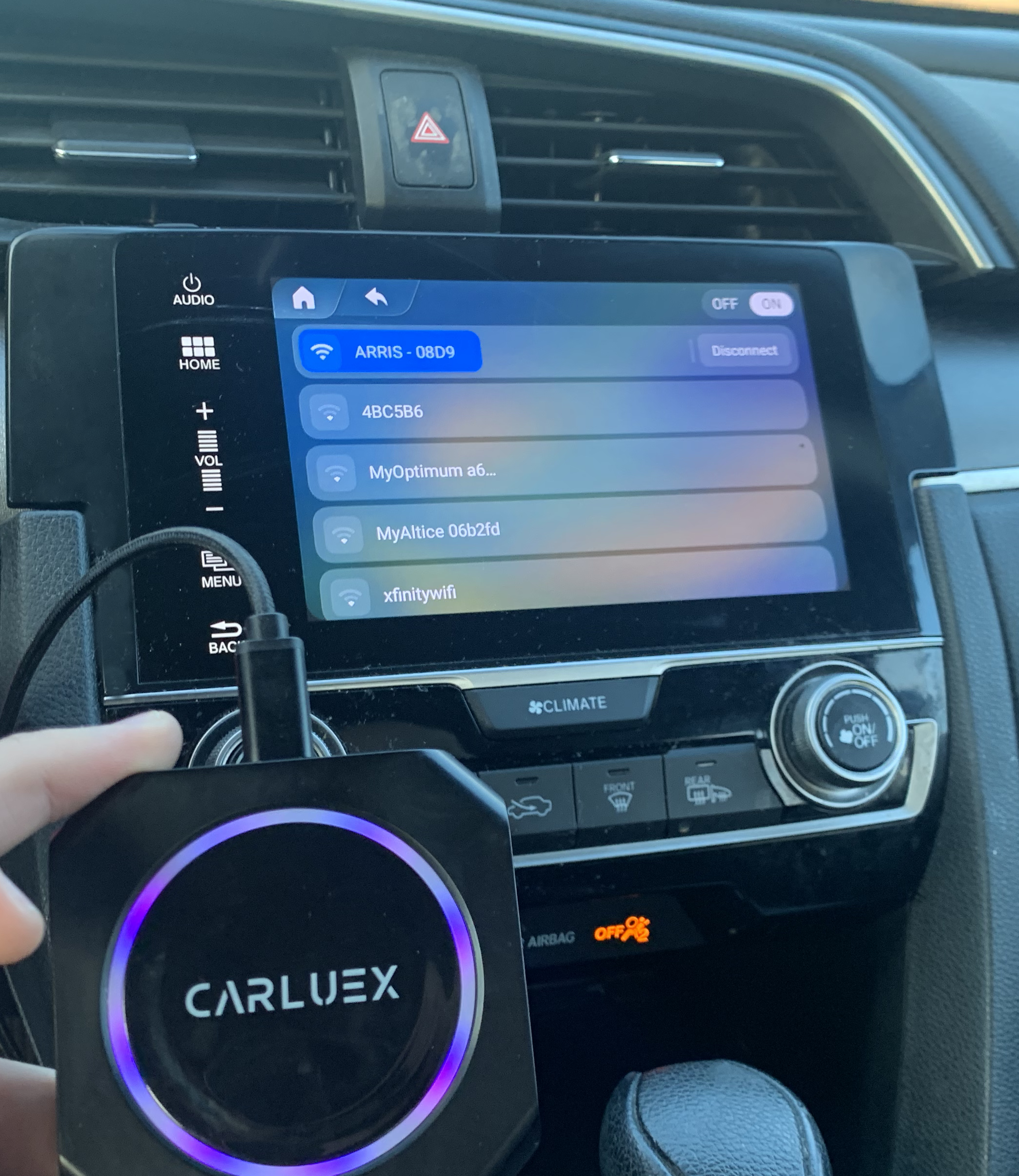 A car dashboard with carluex carplay adapter connected